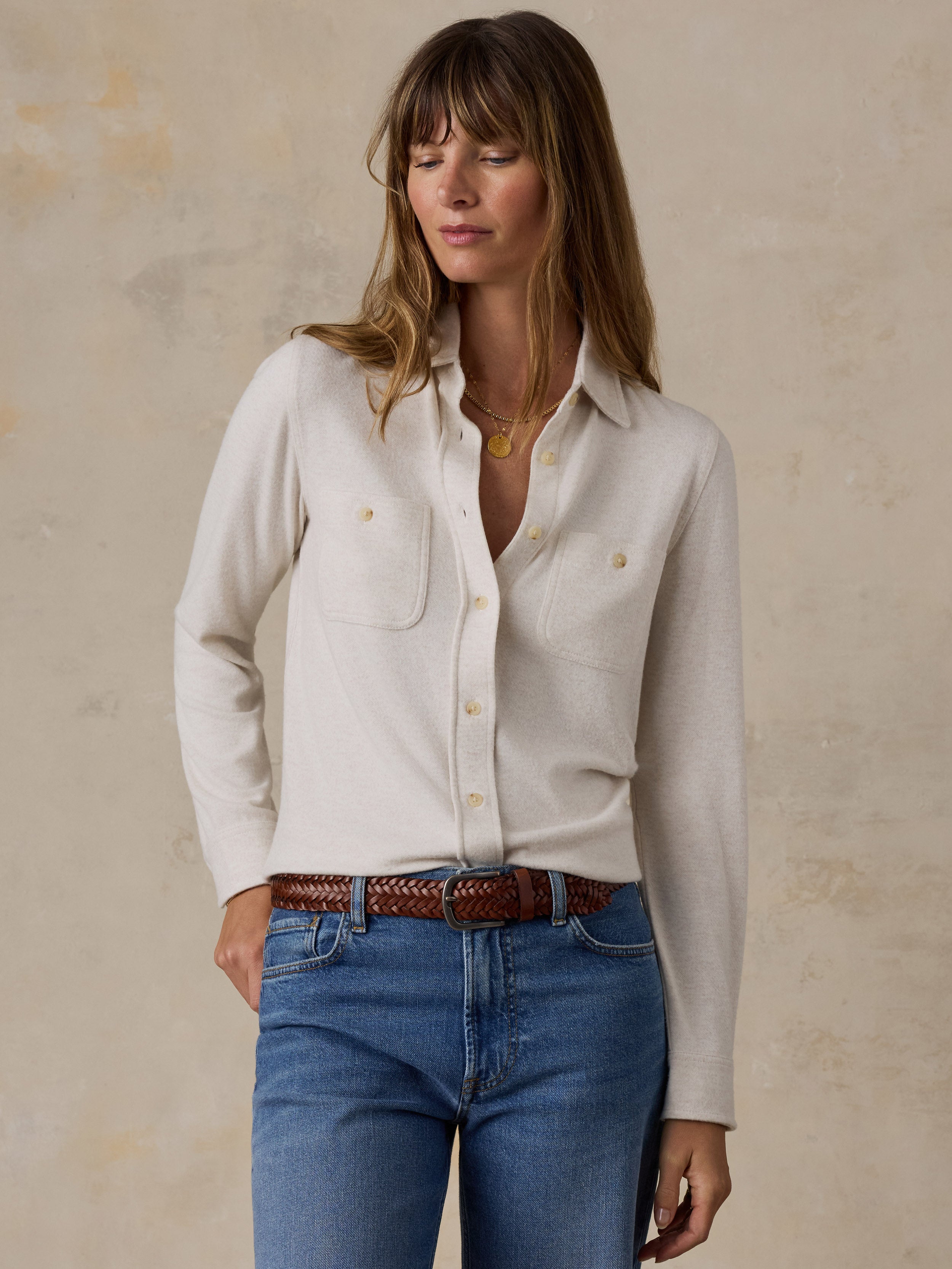 A woman wearing a white shirt and blue jeans