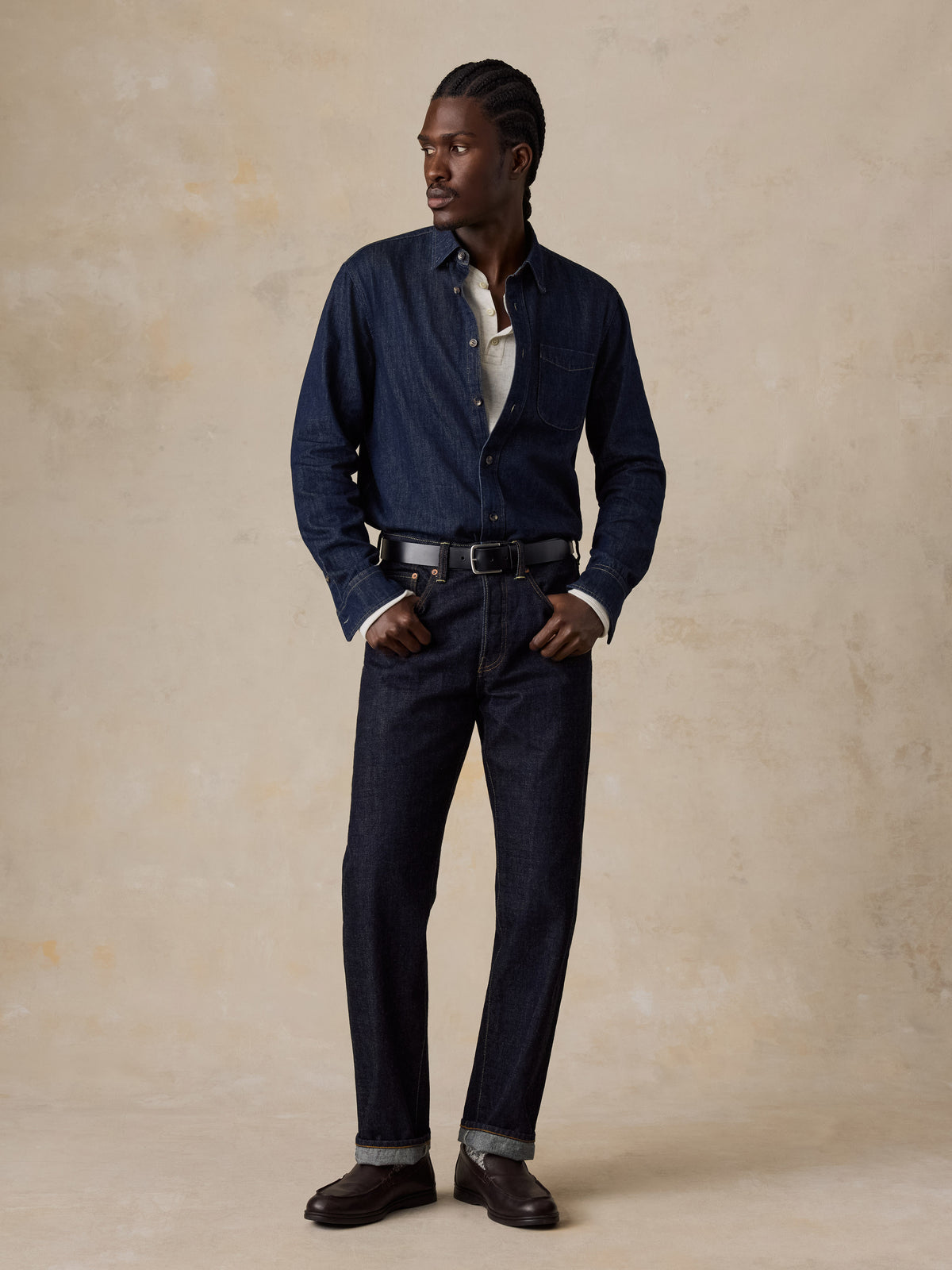 A man wearing blue selvedge denim pants and a blue denim shirt, image 3 of 6