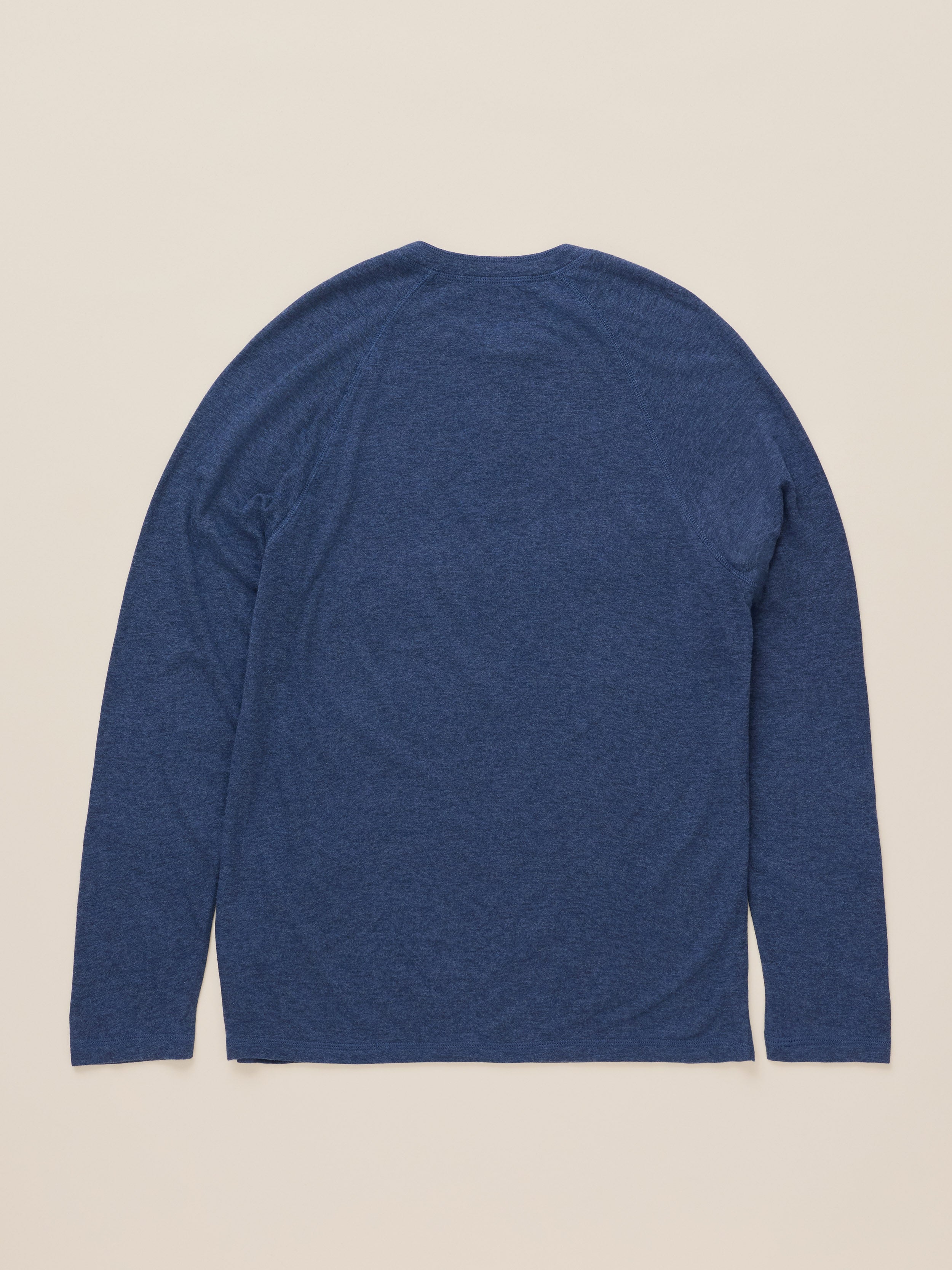 A heathered blue long-sleeve shirt shown from the back, laid flat against a light beige background.