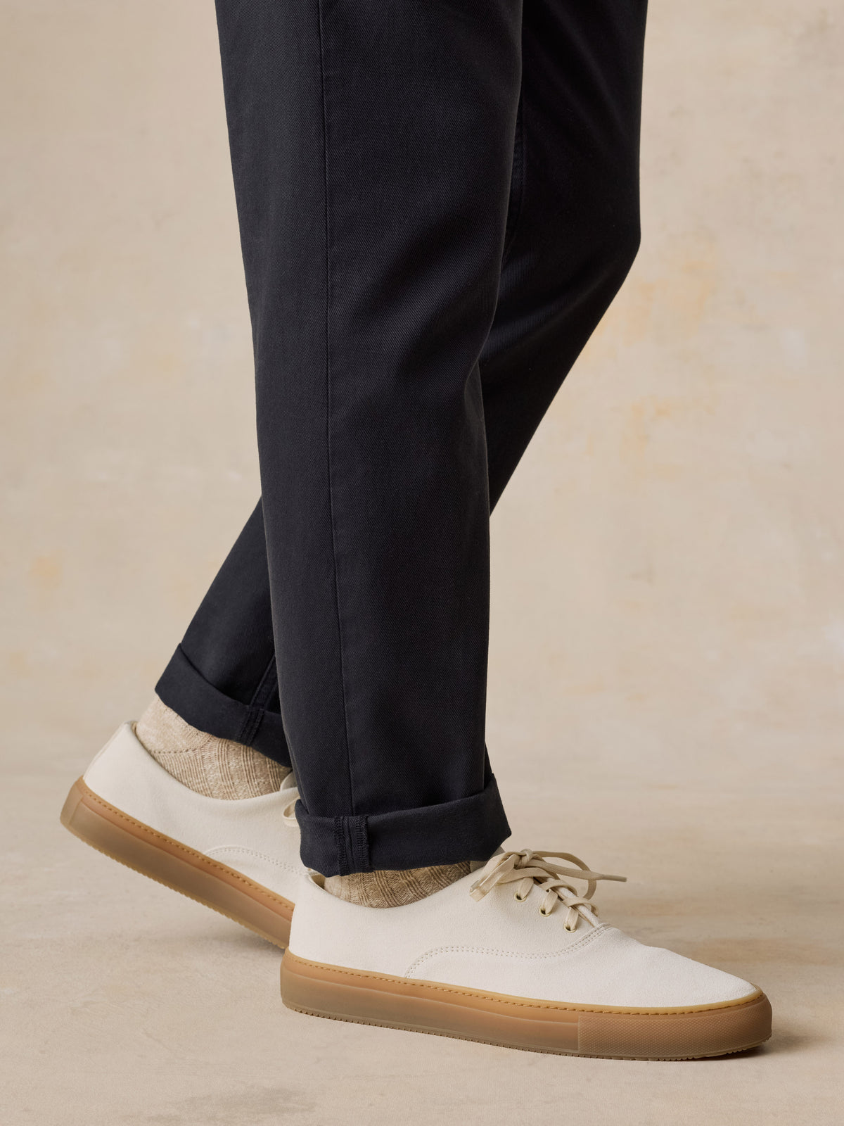 Man wearing black pants and white sneakers, image 5 of 6