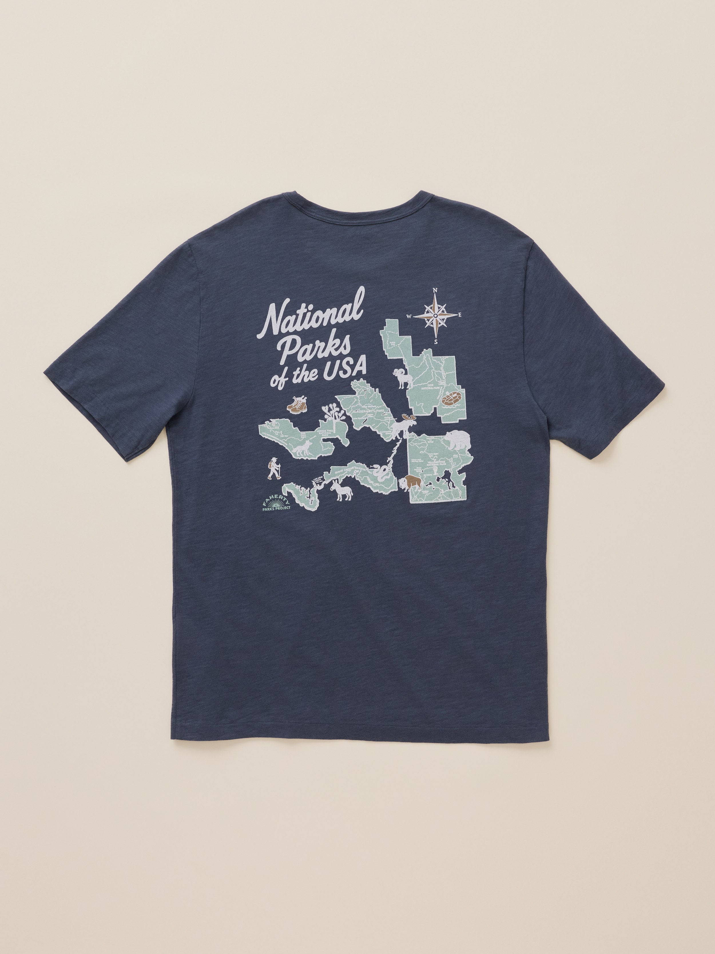 A navy blue short-sleeve t-shirt with a graphic print on the front featuring a map of National Parks of the USA, displayed flat against a light beige background.