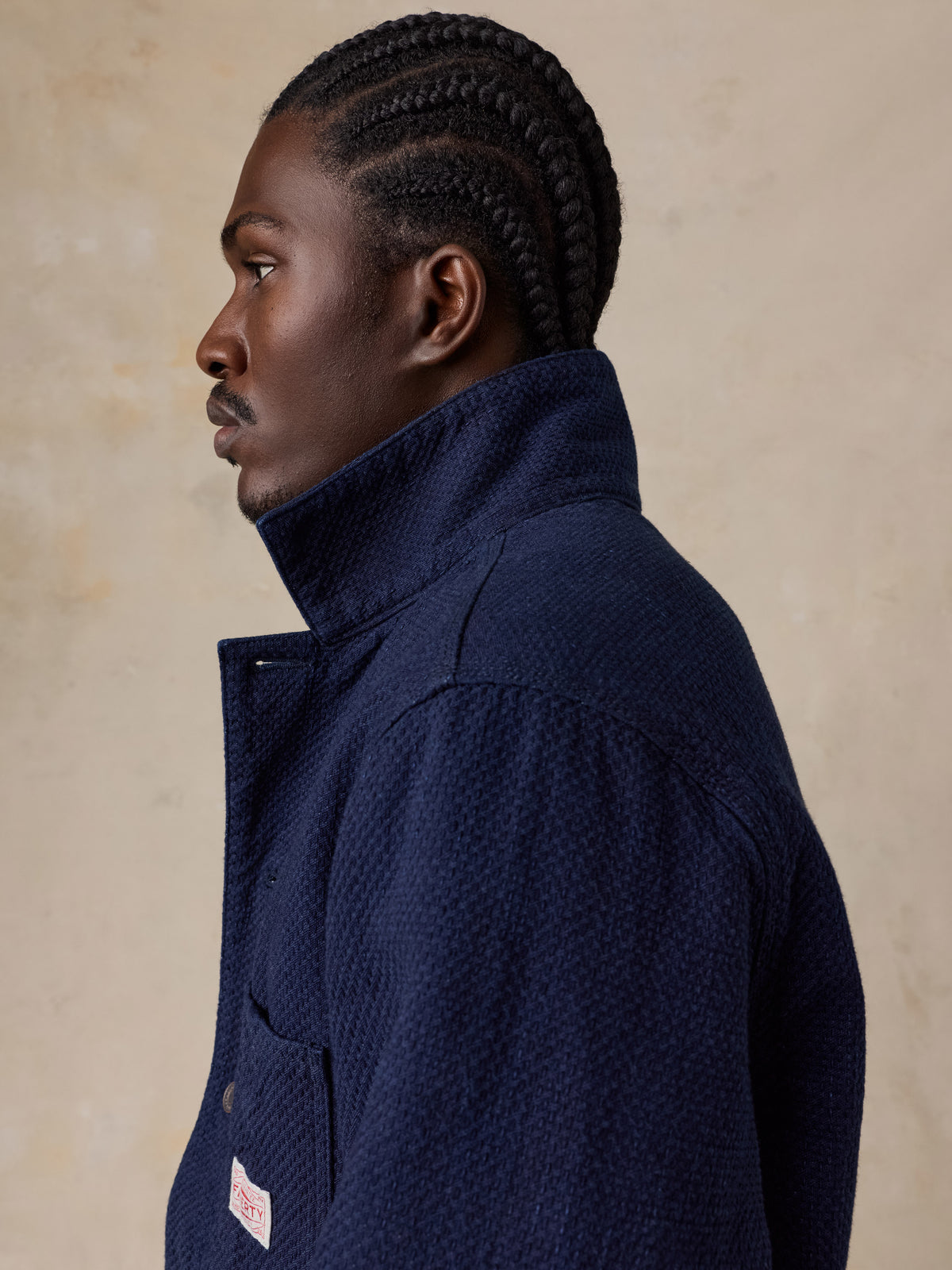 A man wearing a blue jacket , image 5 of 6