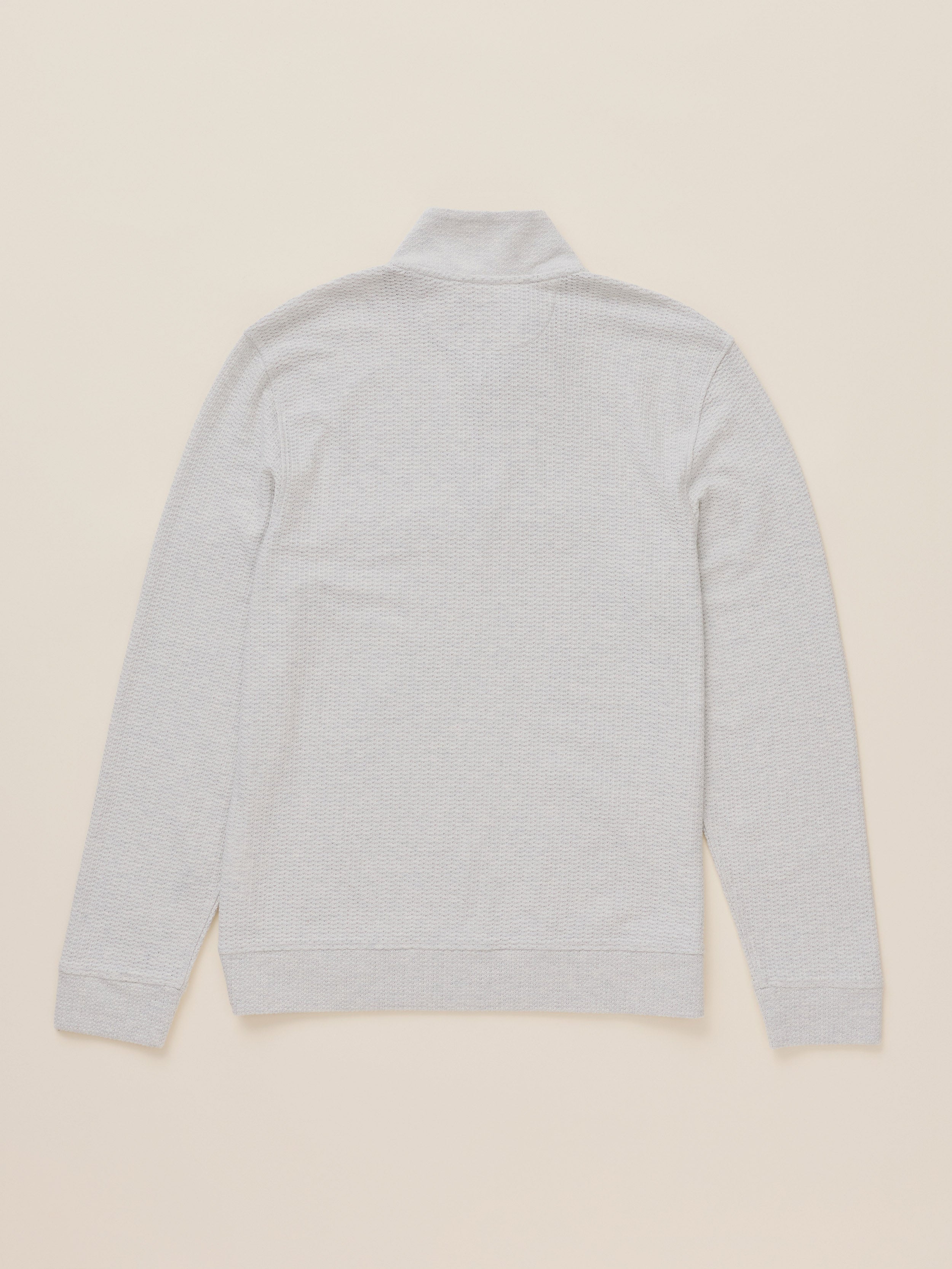 A light gray heather long-sleeve half-zip sweater with a mock neck, shown from the back on a solid beige background.