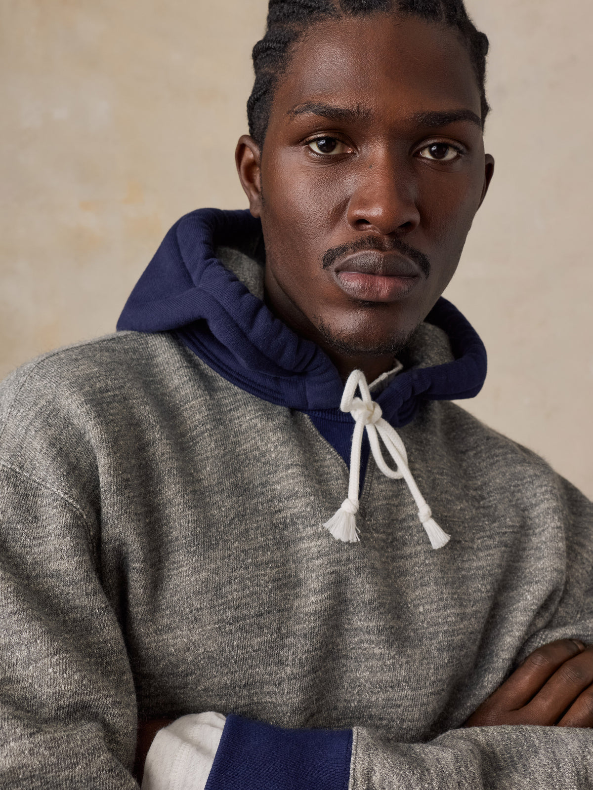 Close up of a man wearing a blue and grey hoodie , image 4 of 5