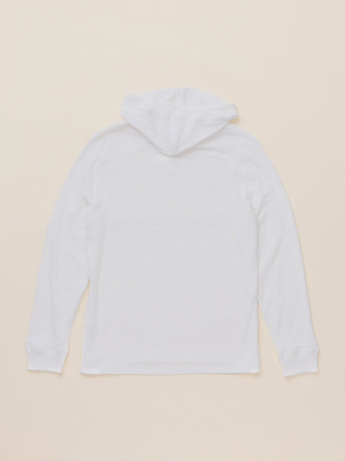 A white hooded long-sleeve shirt shown from the back, laid flat against a solid light beige background., image 8 of 8
