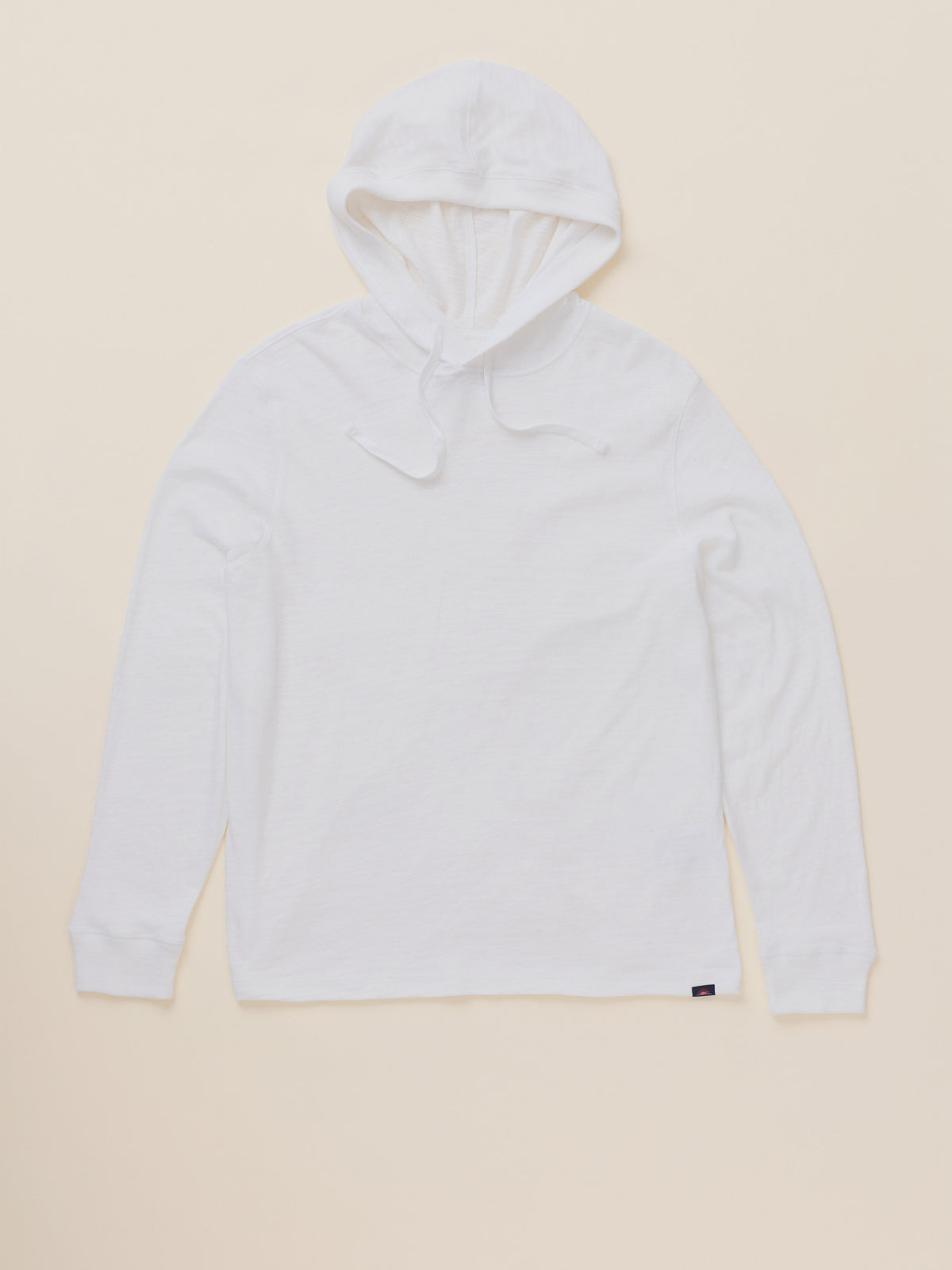 A white long-sleeve hooded shirt with drawstrings, laid flat against a light beige background., image 7 of 8