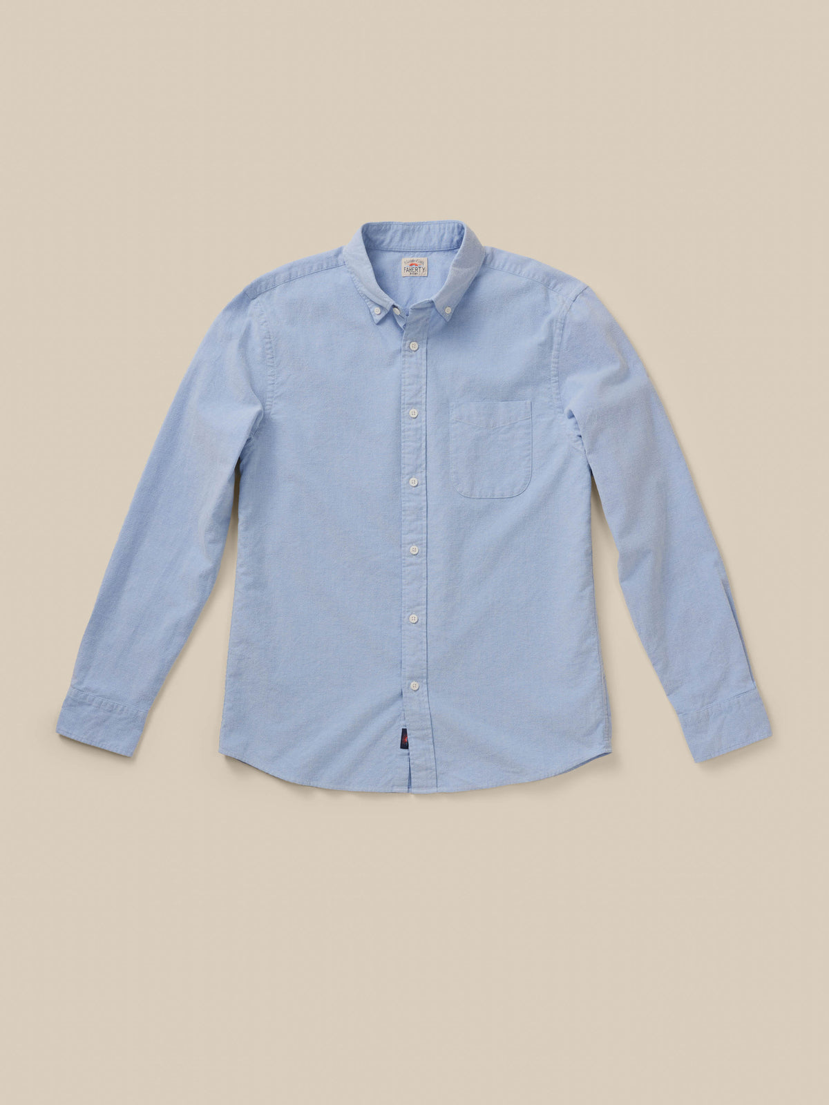 Light blue long sleeve button down shirt against a beige background, image 7 of 9