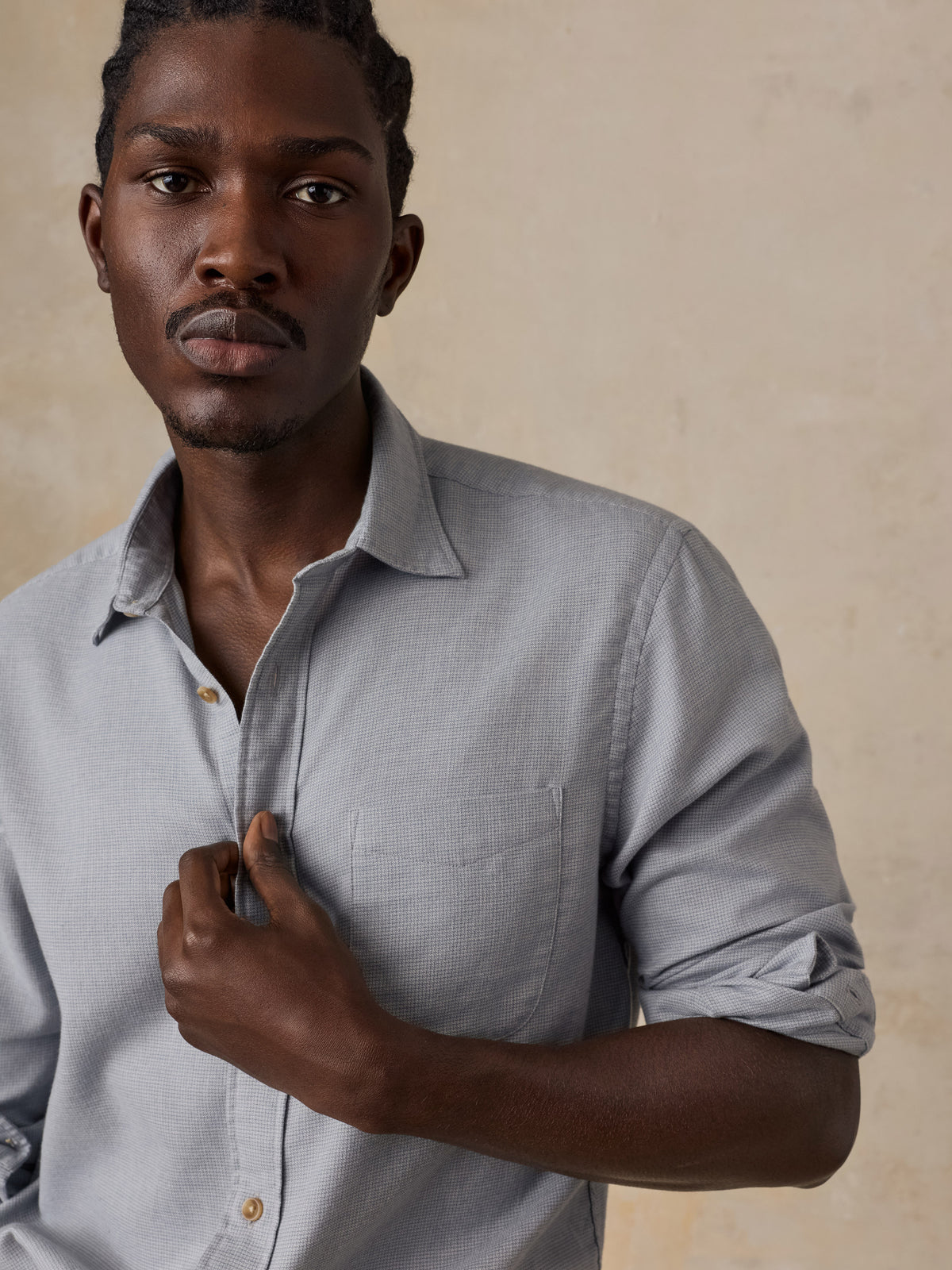 A man wearing a grey shirt , image 5 of 5