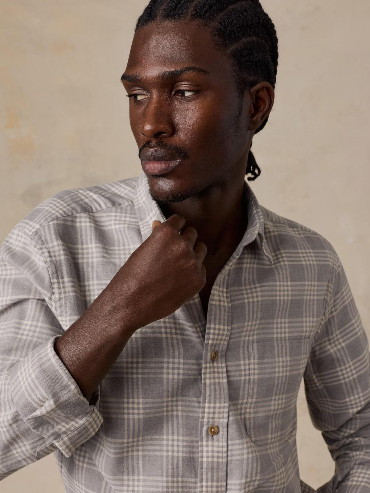 Close up of a man wearing a grey plaid button up shirt, image 5 of 5
