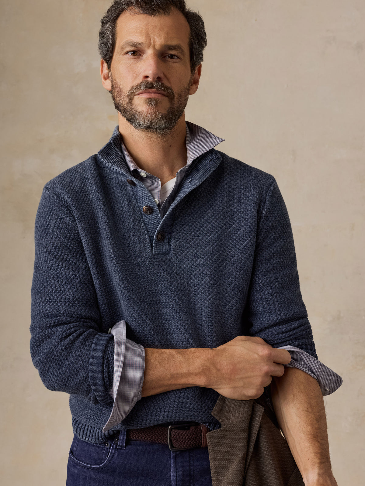 Man wearing a blue button up sweater and navy pants, image 4 of 5