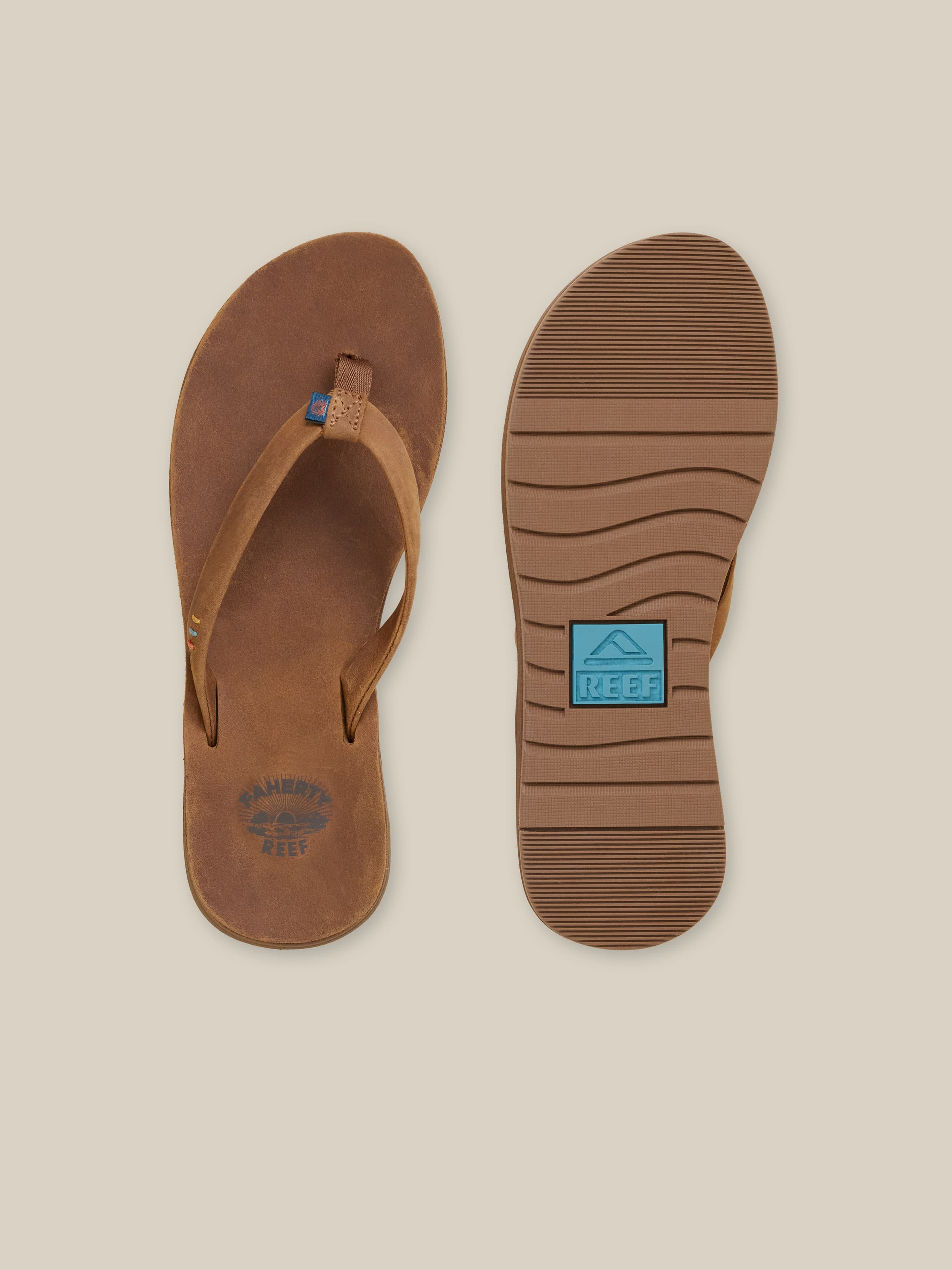 Brown sandal with a visible REEF logo on a beige background