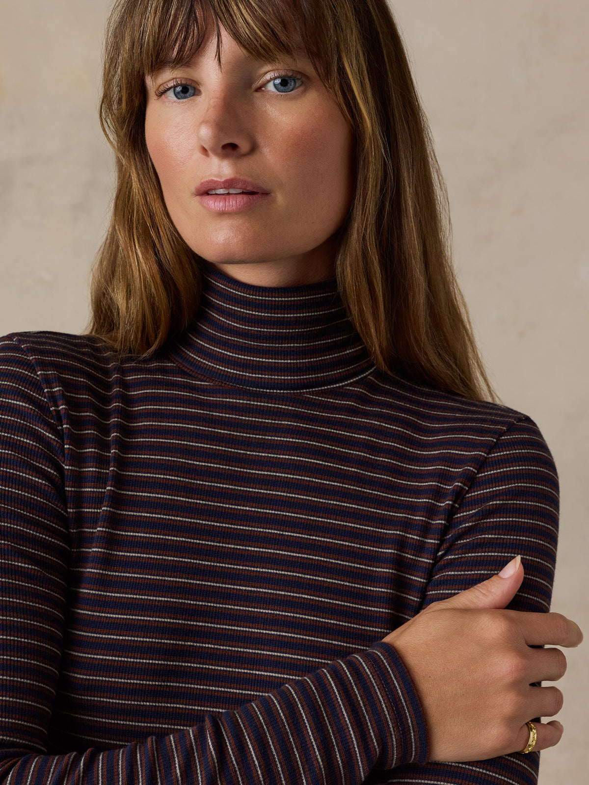 A woman wearing a brown striped turtleneck , image 6 of 6