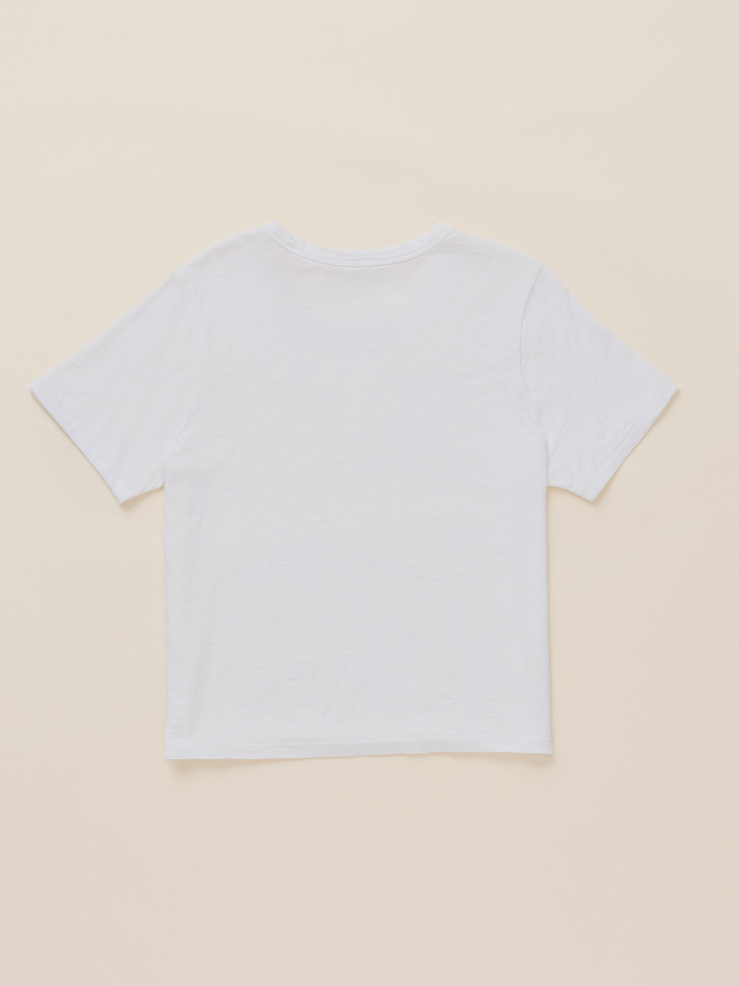 A plain white short-sleeve crop top t-shirt shown from the back, laid flat on a light beige background.