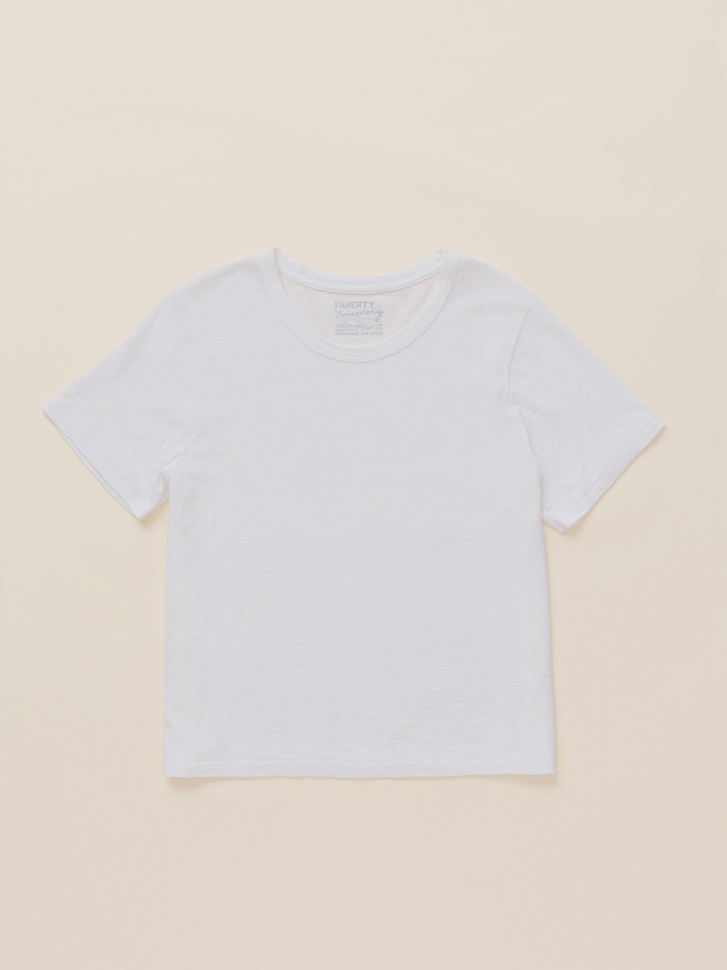 A plain white short-sleeve crewneck t-shirt laid flat against a solid light beige background.