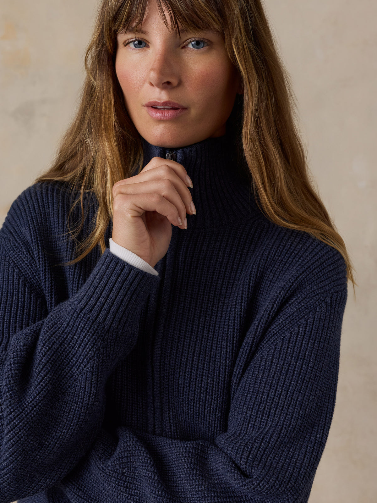 Woman wearing a navy blue quarter zip sweater , image 2 of 6