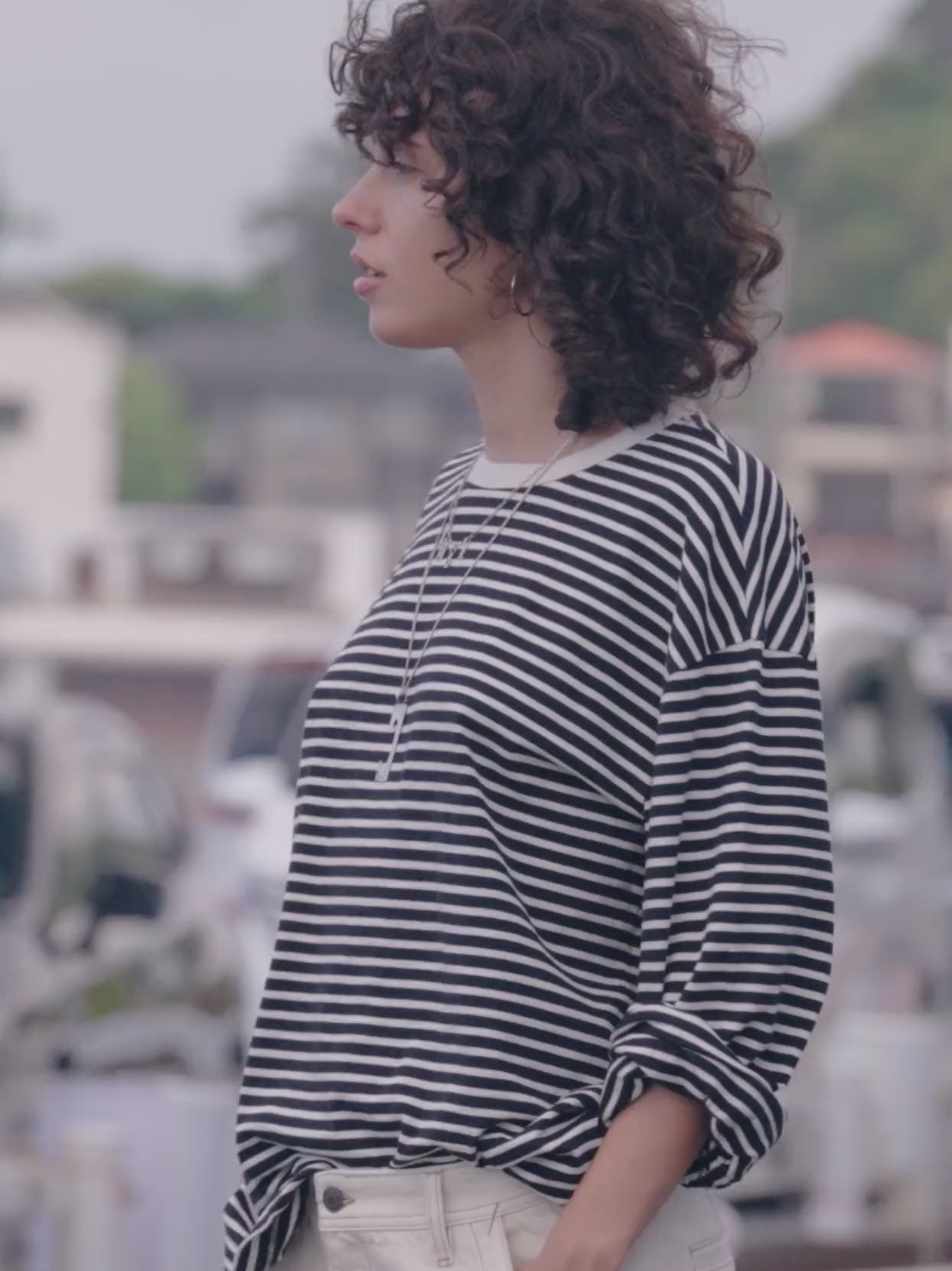 Video of a woman wearing a black and white striped shirt