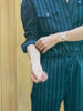 Video of a woman wearing a blue striped matching set in a cabin