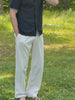 Video of a man standing in a field wearing a navy blue polo and beige chino pants