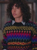 Video of a woman wearing a colorful sweater over a chambray shirt